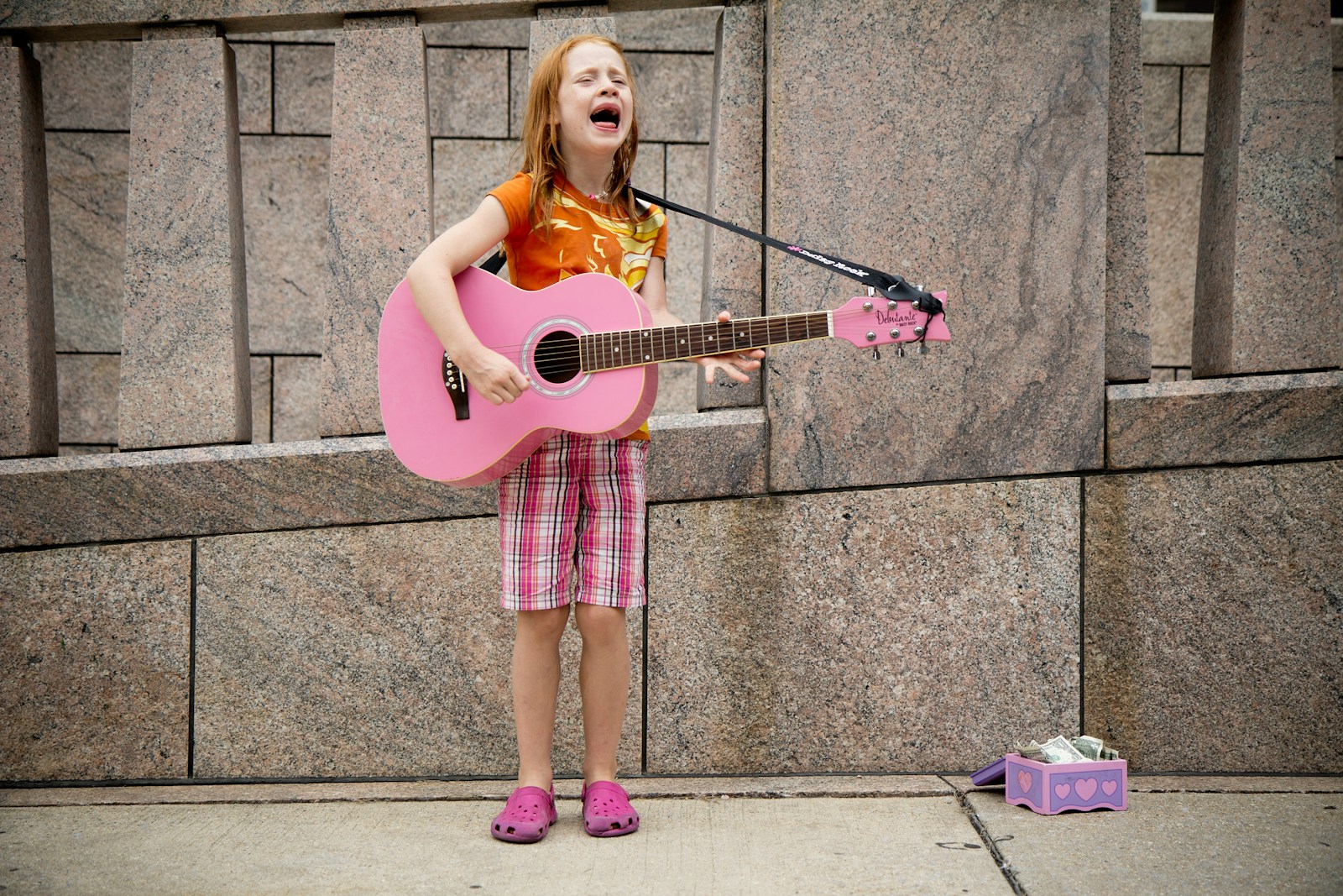 Photo by Felix Koutchinski girl playing guitar near wall
